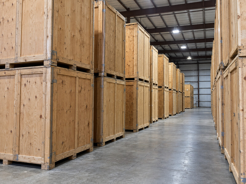 Rows of individual wooden storage vaults in a warehouse